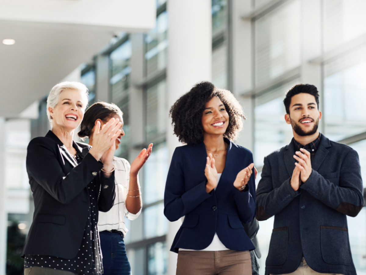Four people clapping their hands.