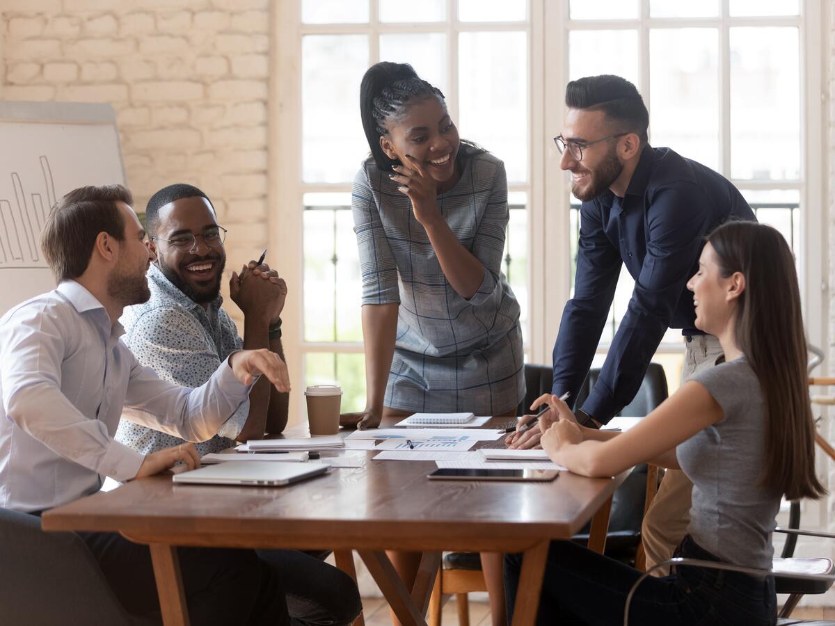 A group of people speaking around a table.