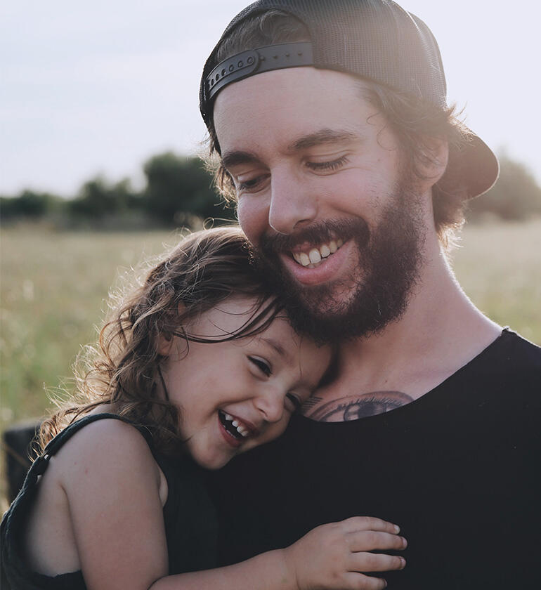 a man and a girl hugging