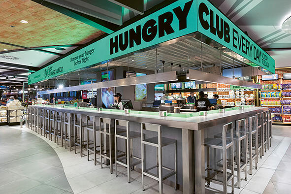 Hungry Club restaurant with a central counter and high stools.